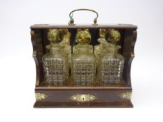 Victorian oak three bottle tantalus with sliding drawer action,