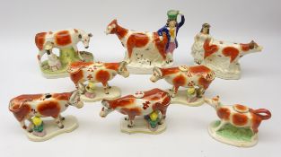 Five 19th century Staffordshire Cow Creamers on shaped bases with milkmaids and pails,