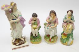 Two Victorian Staffordshire figures modelled as young girls with birds,