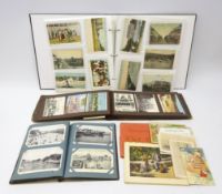 Three albums containing over four hundred and eighty Edwardian and later postcards including real