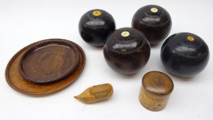 Four lignum vitae bowling balls, turned treen jar and cover,