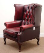 Georgian style wing back armchair, upholstered in deep buttoned Burgundy leather,