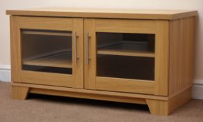 Light oak finish television cabinet, two glazed doors, plinth base, W108cm, H57cm,