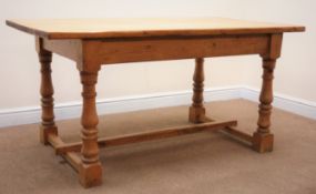 Rectangular country kitchen style pine dining table, turned supports joined by single stretcher,