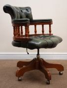 Captain's swivel chair upholstered in green buttoned leather on swivel base,