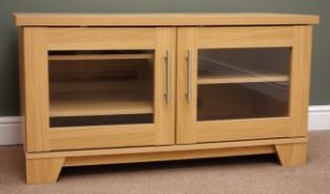 Light oak finish television cabinet, two glazed doors, plinth base, W108cm, H57cm,