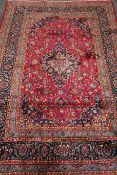 Kashmar red ground rug, central medallion, floral pattern repeating border,