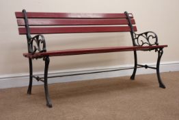 Wrought metal framed garden bench with wooden slats,