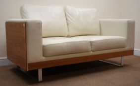 Dwell Furniture walnut framed two seat sofa upholstered in cream leather, chrome supports,