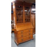 Early 20th century oak bureau bookcase, shell carved projecting cornice,
