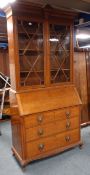 Early 20th century oak bureau bookcase, shell carved projecting cornice,