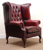 Georgian style wing back armchair, upholstered in deep buttoned Burgundy leather,