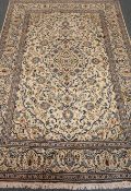 Kashan beige and blue ground rug, repeating border, floral field, central medallion,