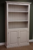 Painted pine bookcase, projecting cornice, two shelves above tow cupboard doors, plinth base,