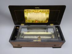 Late 19th century Swiss music box the ebonised and cross-banded case inlaid with musical trophies