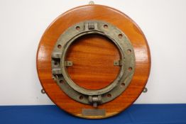 M.V Fred Everard - Large circular three bolt porthole on wooden plaque, D56cm.