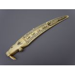Scrimshaw Walrus tusk Cribbage board, decorated with seals heads and whale in relief,