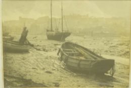 Early 20th century monochrome photograph of fishing boats in Whitby Harbour at low tide,