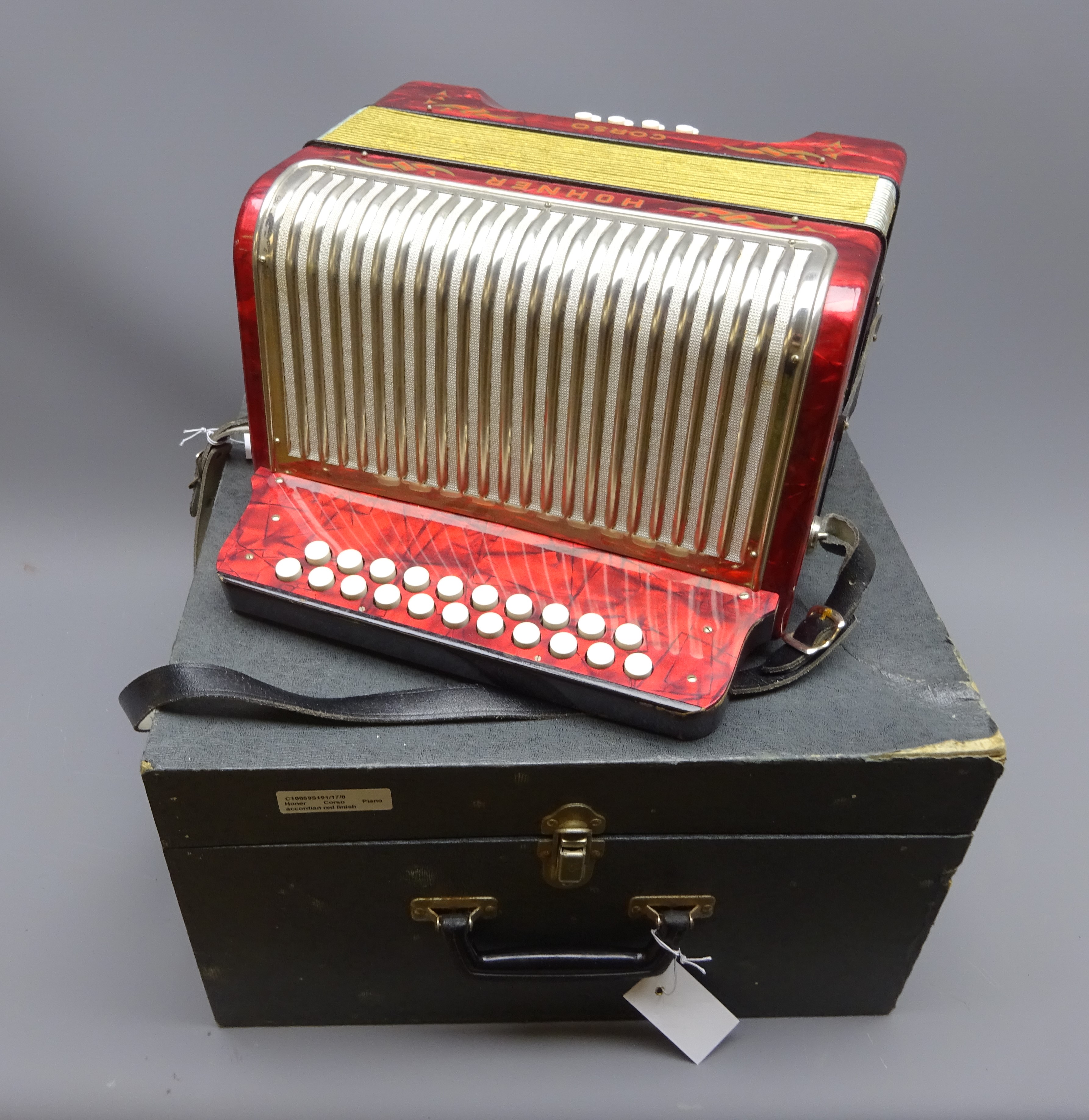 Hohner Corso twenty-nine button accordion with red pearline and white metal case W31cm,