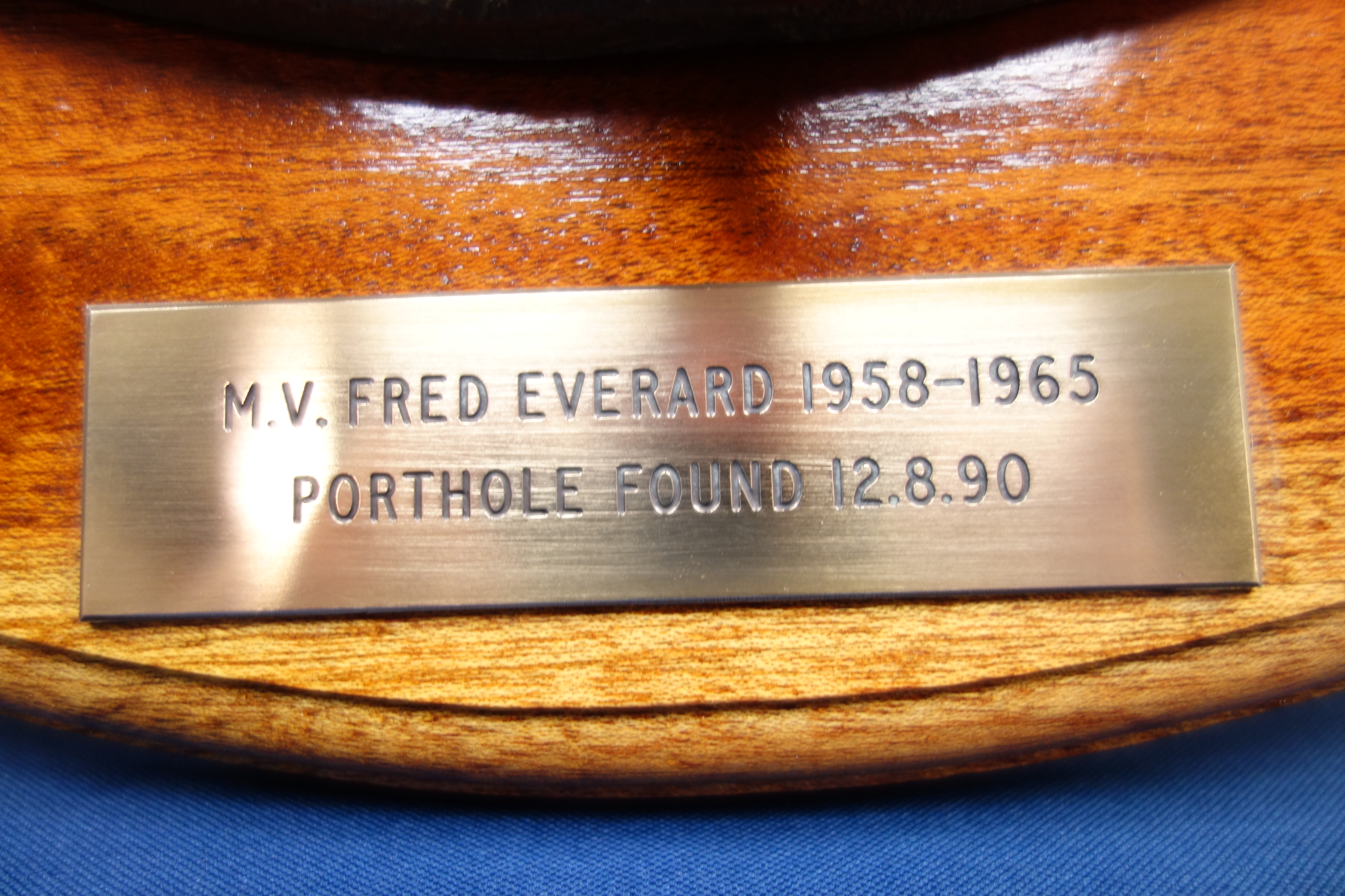 M.V Fred Everard - Large circular three bolt porthole on wooden plaque, D56cm. - Image 2 of 3