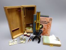 20th century lacquered brass monocular microscope on black painted metal base with rack and pinion