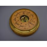 Russian aneroid barometer, circular salmon dial with subsidiary temperature dial and brass bezel,
