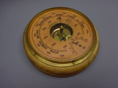 Russian aneroid barometer, circular salmon dial with subsidiary temperature dial and brass bezel,