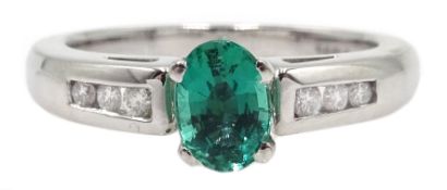 18ct white gold oval emerald ring, with round brilliant cut diamond shoulders,