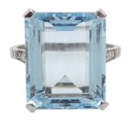 Platinum emerald cut aquamarine ring with diamond set shoulders,