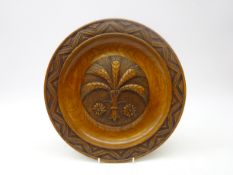 Carved elm alms collection dish, central floral motif within geometric border,