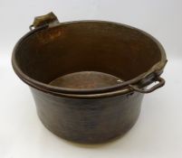 Eastern hammered copper pan with swing iron handle on rounded base,