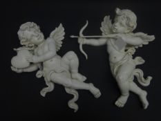 Two modern wall mounted Cupid figures, white finish,