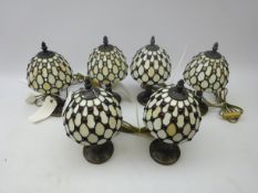 Set of three Tiffany style table lamps with ruby glass cabochons together with a similar set of