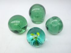 Three Victorian glass dumps with internal flower decoration and another with yellow internal flower