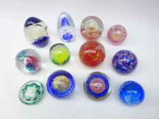 Collection of glass paperweights including Hokitika, Caithness style examples and others,