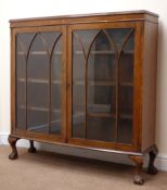 Early 20th century oak bow front display cabinet, two doors enclosing three shelves,