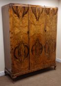 Early 20th century figured walnut triple wardrobe, three doors enclosing fitted interior,