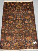 Antique Baluchi black ground rug, repeating border,