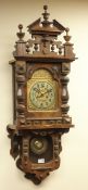 Victorian walnut wall clock, arched dial and Silesia Gloria movement with two glazed doors,