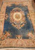 Large Chinese blue ground washed woollen rug carpet, central medallion, floral repeating border,