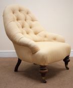 Victorian salon armchair, upholstered in a deep buttoned natural fabric, turned supports on castors,
