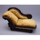 Late 19th/early 20th century doll's chaise longue with mahogany stained carved frame,