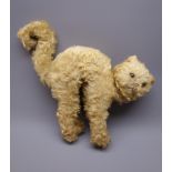 Merrythought plush covered straw filled cat in a startled pose with arched back and curled tail,