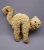 Merrythought plush covered straw filled cat in a startled pose with arched back and curled tail,