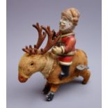 Early 20th century clockwork figure of Father Christmas with composition head and tin-plate body,