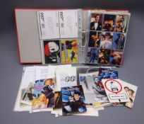 James Bond paper ephemera, loose and in an album, including various sets of collectors cards,