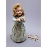 Early 20th century French Henri Rostal Mon Tresor bisque head musical pull-along doll,