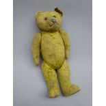 Early 20th century teddy bear with straw filled body, applied eyes,