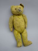 Early 20th century teddy bear with straw filled body, applied eyes,