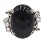 14ct white gold (tested) black star diopside and four round brilliant cut diamond ring